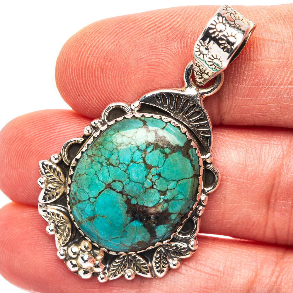 Turquoise cabochon pendant in ornate .925 sterling silver setting, round bezel