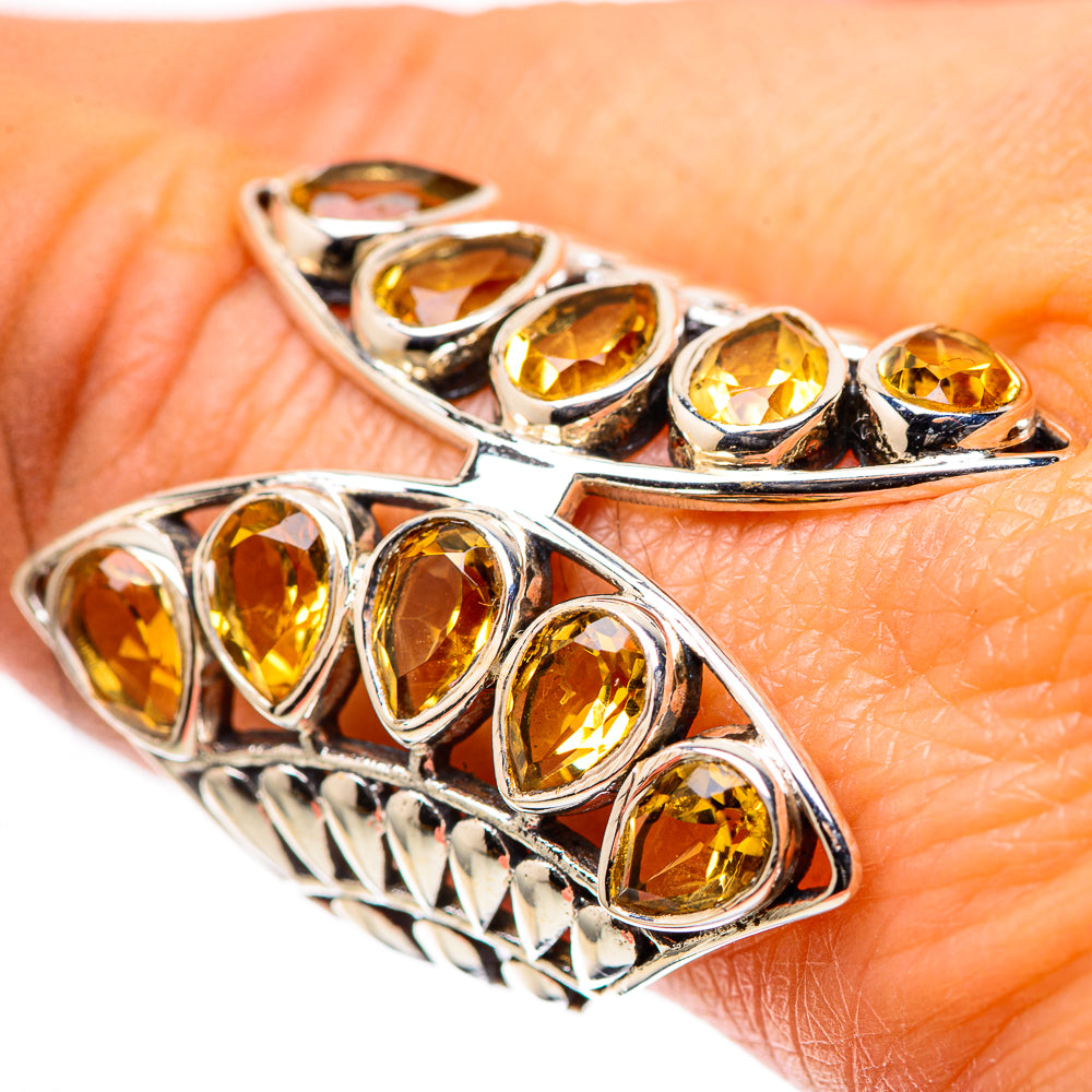 Large oval citrine ring in 925 sterling silver with faceted yellow stones, split band.