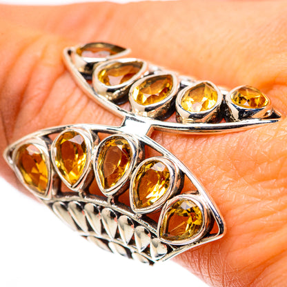 Large oval citrine ring in 925 sterling silver with faceted yellow stones, split band.