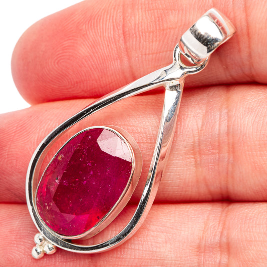 Sterling silver teardrop pendant with oval dark pink ruby cabochon
