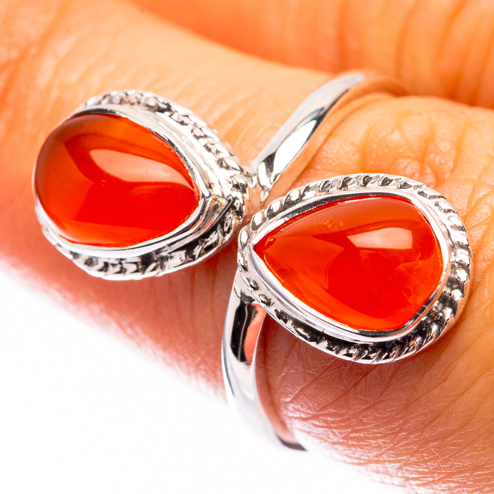 Silver-tone ring with two oval orange-red carnelian stones in ornate twisted setting