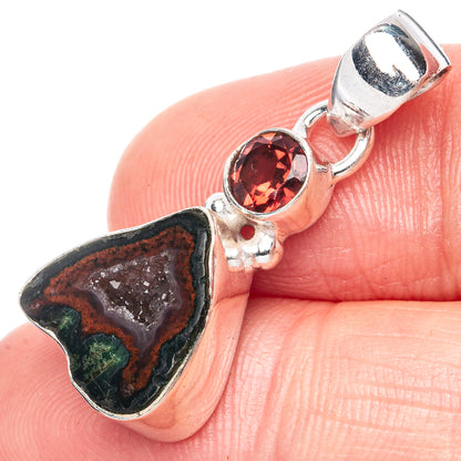 Sterling silver pendant with dark geode slice and bezel-set red round gemstone