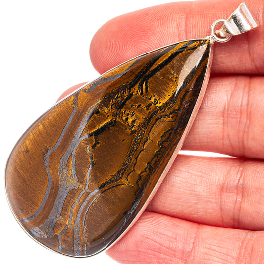 Tiger's eye teardrop pendant with silver-plated bail; golden-brown stone with dark bands