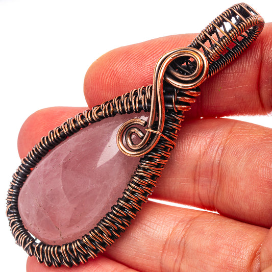 Oxidized copper wire-wrapped rose quartz teardrop pendant with spiral loops