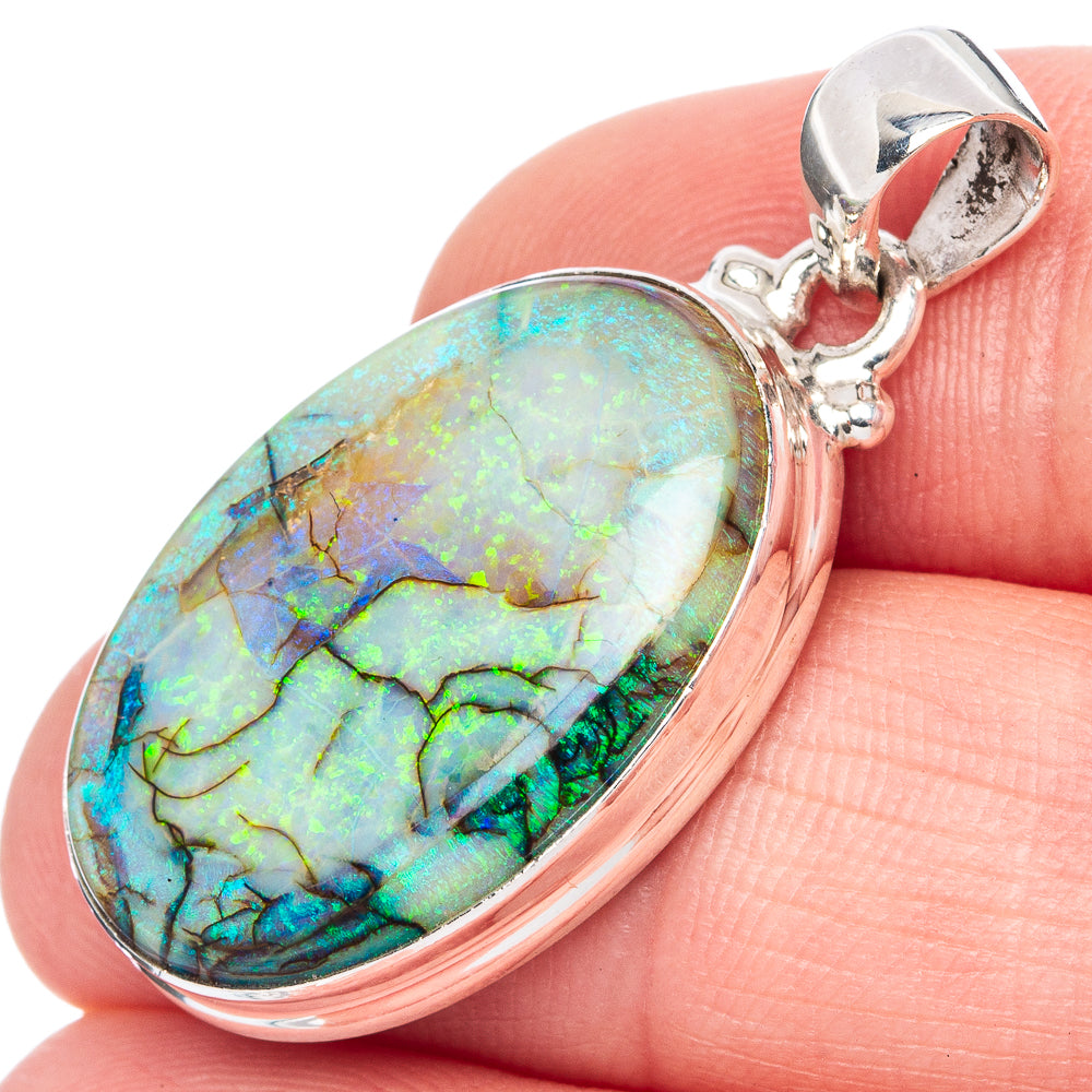 Oval opal cabochon sterling silver pendant with shiny bail, blue-green iridescent flashes.