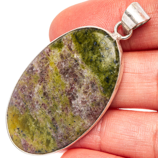 Silver-plated oval pendant with green and purple speckled stone, top bail visible