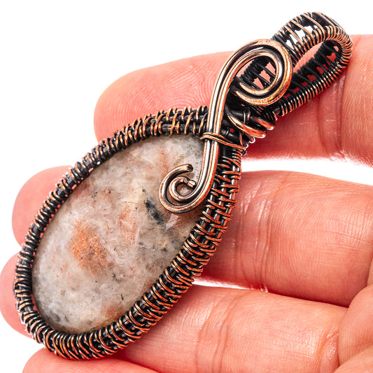 Oxidized copper wire-wrapped teardrop pendant with beige stone cabochon