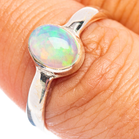 Opal sterling silver ring with oval Ethiopian opal center on finger, size 7.5