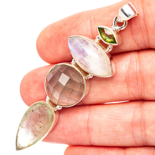 Sterling silver gemstone pendant with three linked stones: green, purple, smoky.