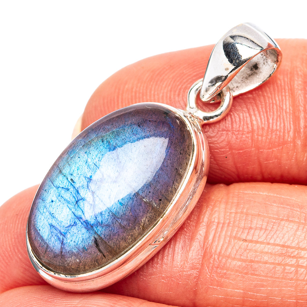 Oval blue flash gemstone pendant in .925 sterling silver bail with polished frame