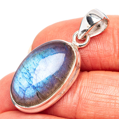 Oval blue flash gemstone pendant in .925 sterling silver bail with polished frame