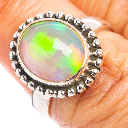 Close-up of .925 sterling silver opal ring with round glowing stone and bead border