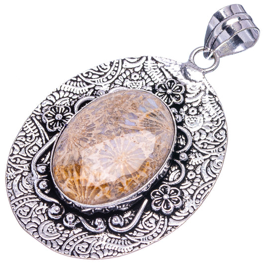 German silver coral pendant with oval stone framed by ornate floral filigree bail