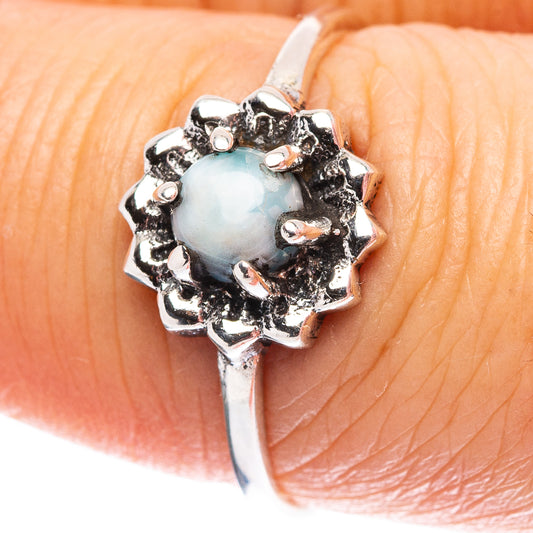 Sterling silver ring with round light-blue larimar-style center and ornate prong setting