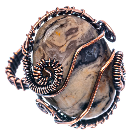 Oxidized copper wire-wrap ring with oval fossil stone and blackened coil accents