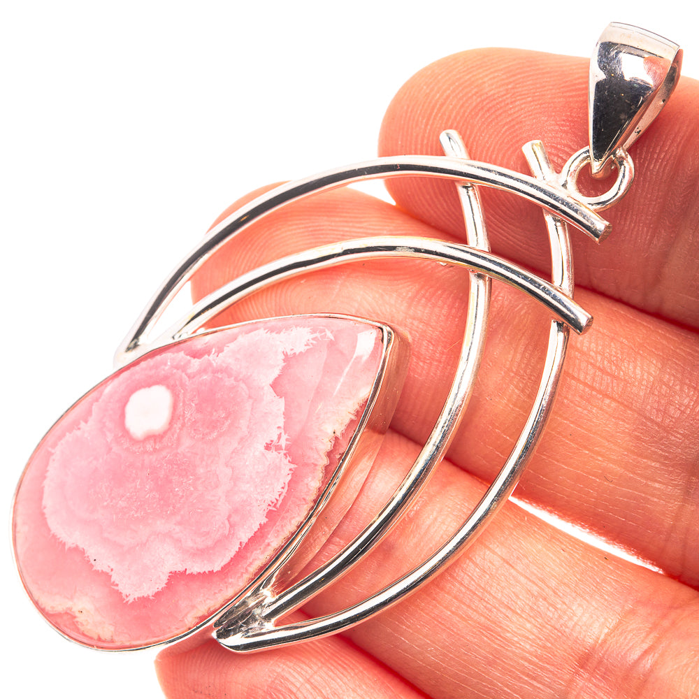 Sterling silver rhodochrosite teardrop pendant with pink stone and curved metal loops