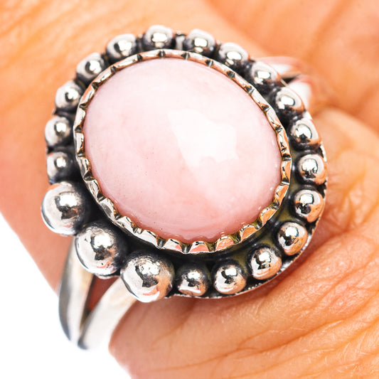 Sterling silver pink opal ring with round bead bezel and raised oval cabochon