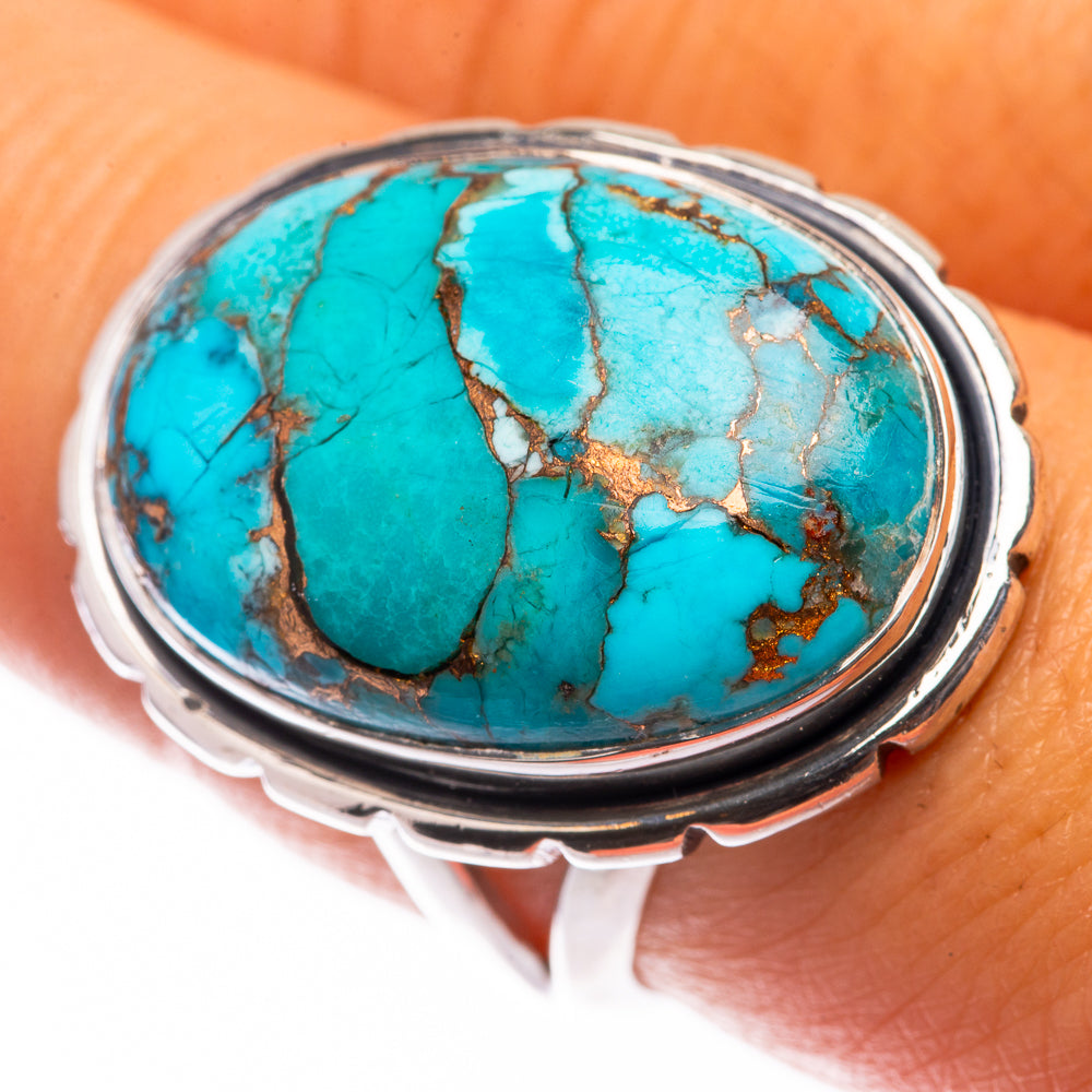 Turquoise oval cabochon ring in silver-tone setting with copper veining
