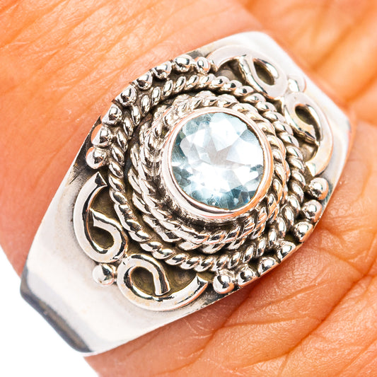 Sterling silver blue topaz ring with ornate rope setting and oval blue gemstone