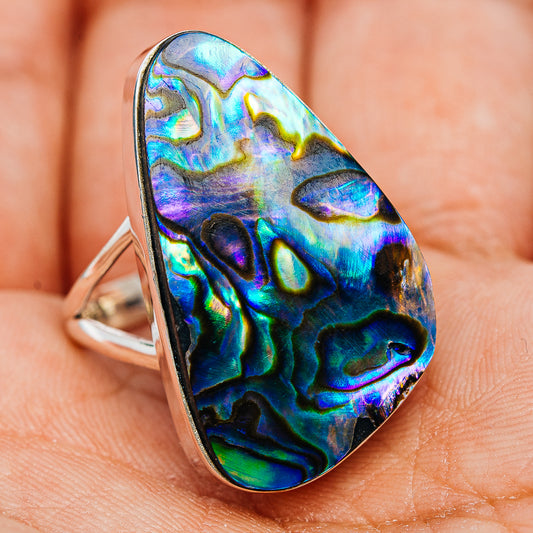Sterling silver abalone inlay ring on hand, iridescent blue-purple oval teardrop shell