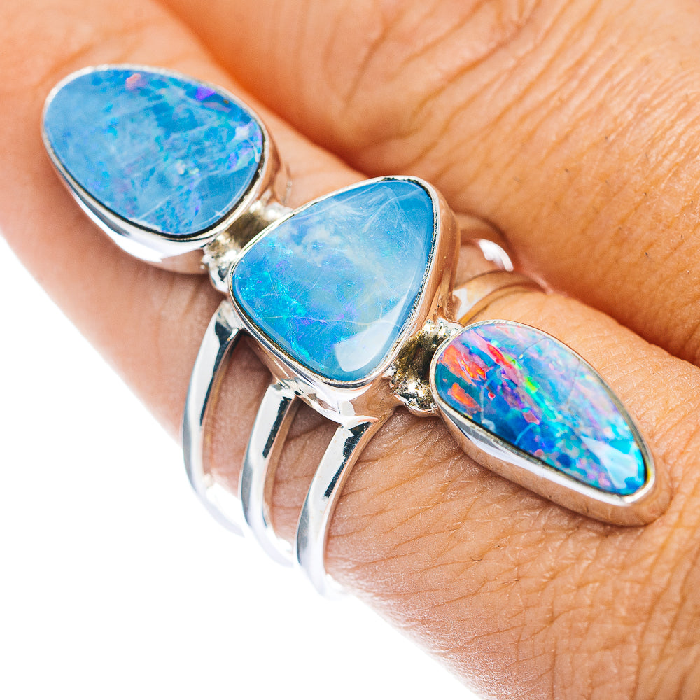 Sterling silver ring with three blue teardrop opal cabochons, open settings