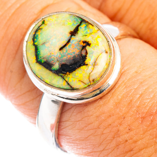 Sterling silver opal ring with oval bezel, green-yellow stone with dark veining