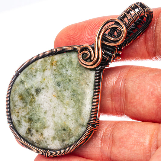 Oxidized copper wire-wrapped teardrop pendant with green speckled stone