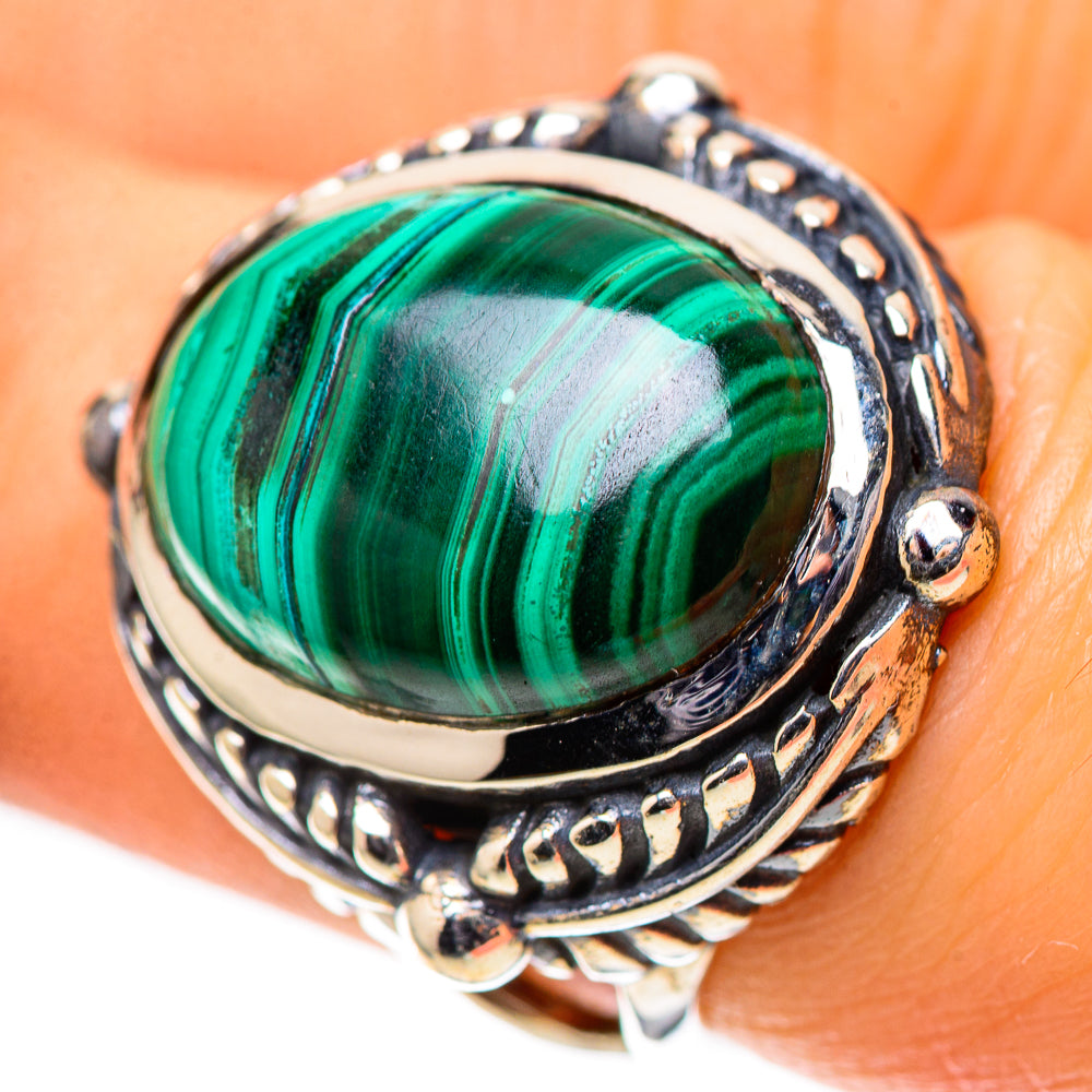 Sterling silver ring with oval green malachite cabochon and ornate vintage-style band