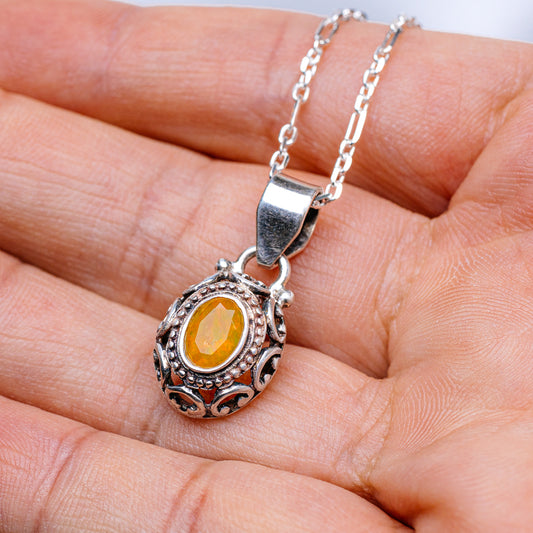 Sterling silver fire opal pendant necklace with oval orange opal in filigree frame
