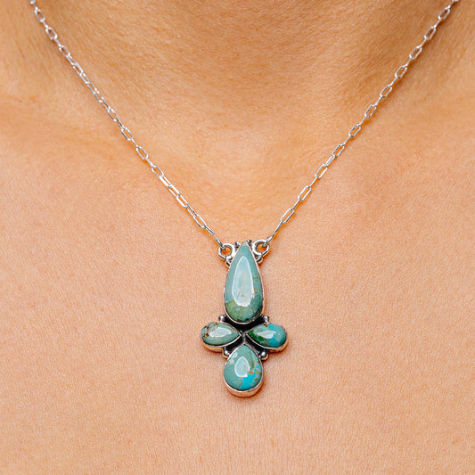 Turquoise teardrop pendant necklace with sterling silver chain and flower setting