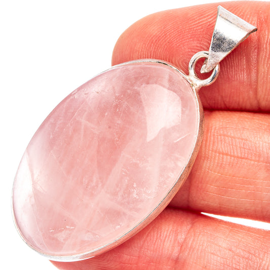 Silver-plated rose quartz pendant with oval pink stone and small bail.
