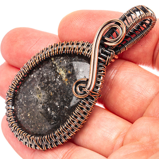 Oxidized copper wire-wrapped pendant with dark sunstone teardrop and loop bail