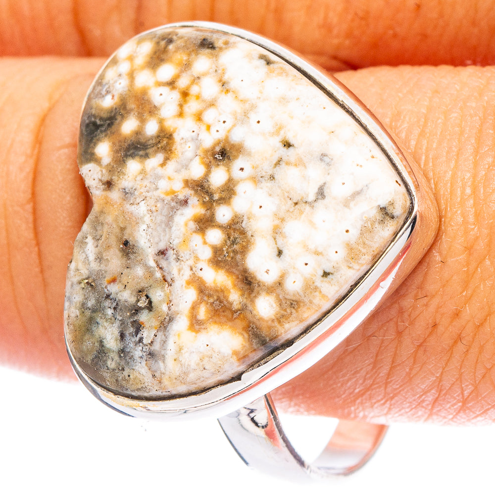 Heart-shaped ocean jasper gemstone ring with silver band, marbled gold and gray.