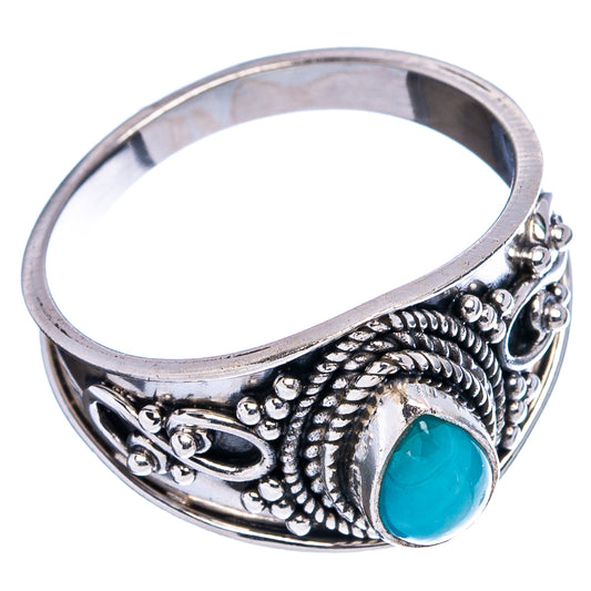 Ornate .925 sterling silver cocktail ring with blue oval gemstone, side view