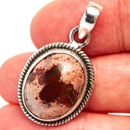 Round sterling silver opal pendant with red fire opal cabochon and braided bezel