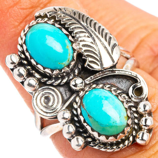 Turquoise and silver statement ring with oval turquoise cabochon and beadwork accents.