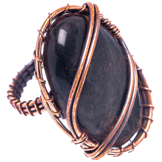 Oxidized copper wire-wrapped jet oval ring, side view with layered wraps