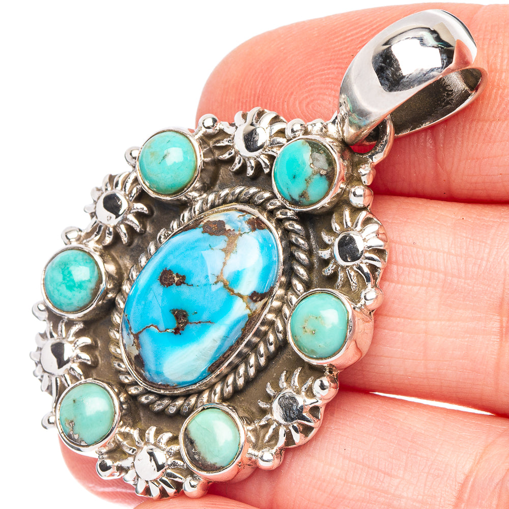 Turquoise and silver Native-style pendant with oval center cabochon and round turquoise accents