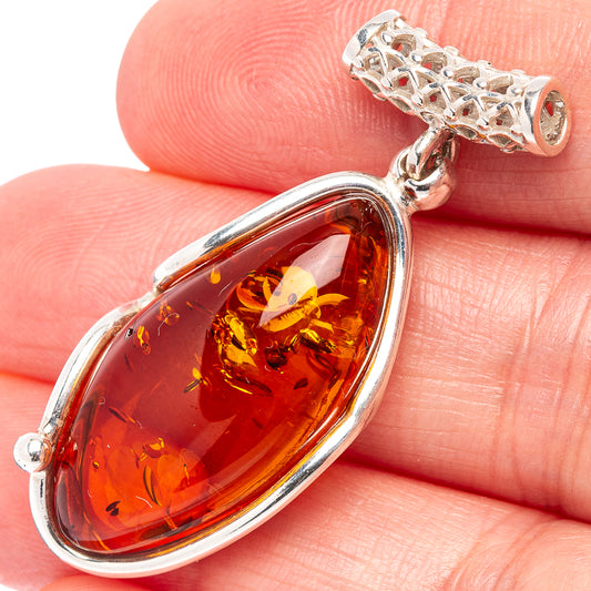 Amber teardrop pendant with .925 sterling silver bezel and textured bail