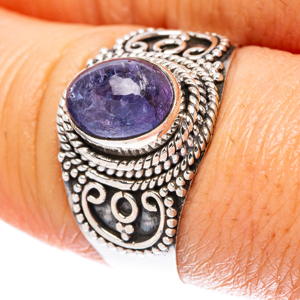 Sterling silver ring with oval purple gemstone and ornate filigree band