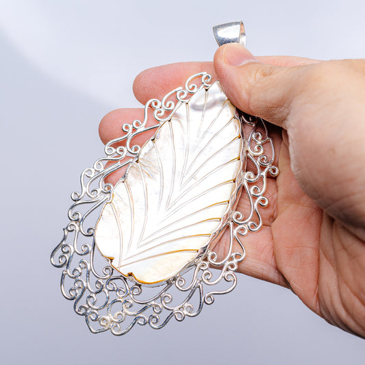 Mother of pearl leaf pendant with swirling .925 sterling silver filigree border