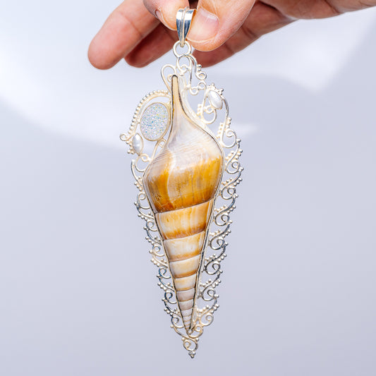 Silver teardrop pendant with amber-striped shell center, blue druzy top, link bail