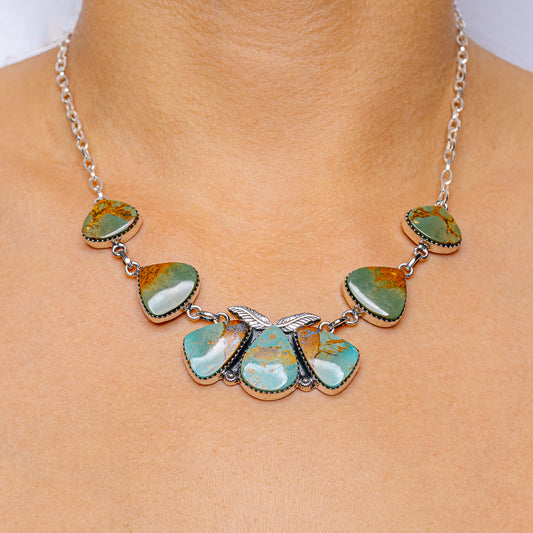Turquoise pendant necklace with oval and teardrop stone accents on silver chain