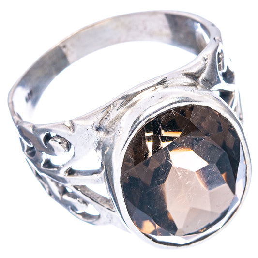 Sterling silver ring with oval smoky quartz centerpiece and swirling openwork design.