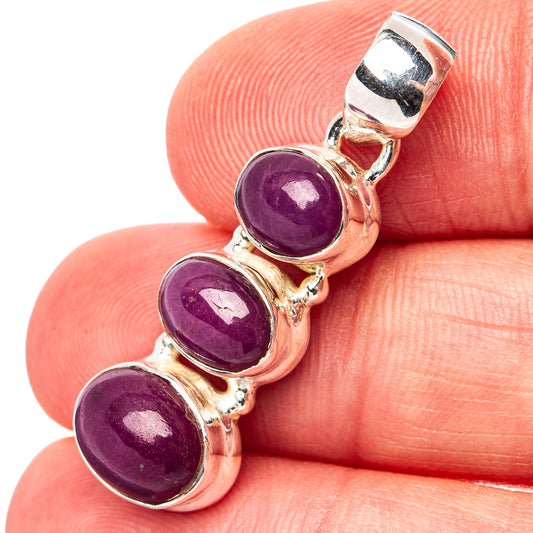 Three-stone sterling silver pendant with three purple cabochon gems and bail