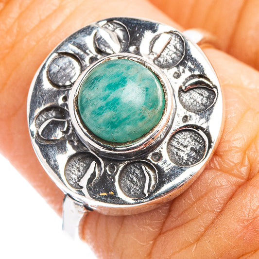 Sterling silver turquoise cabochon ring with round bezel and engraved filigree