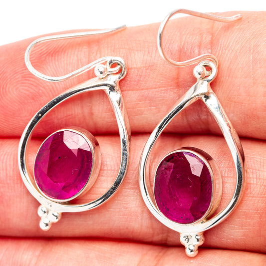 Sterling silver teardrop earrings with deep pink faceted gemstone and dangling bead accents