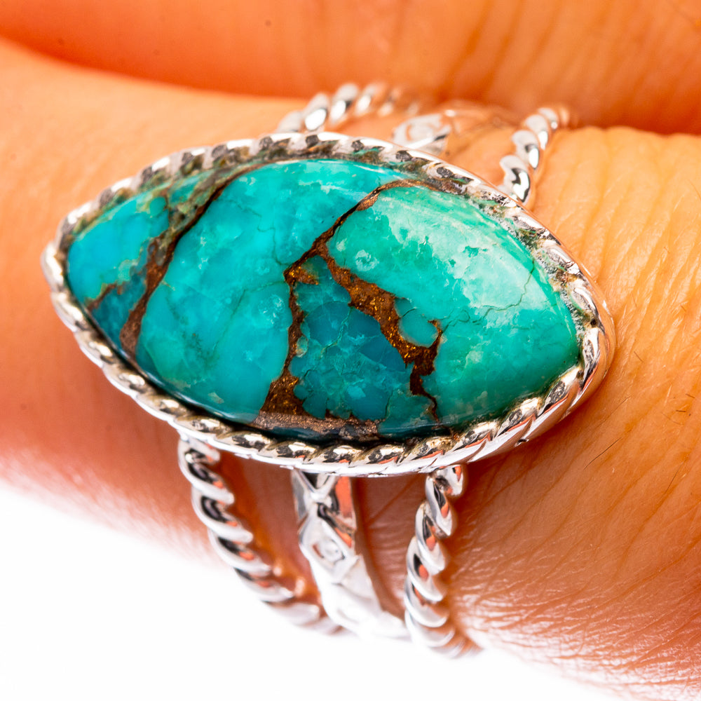Sterling silver turquoise ring with oval blue-green stone and copper web inlay