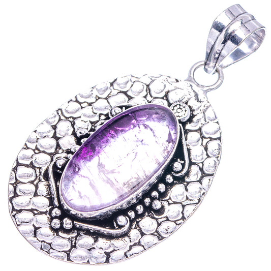Antique silver amethyst pendant with oval purple stone and textured frame