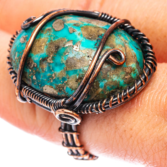 Turquoise wire wrap ring with oxidized copper band and oval stone centerpiece